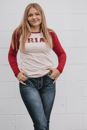 Ariat baseball tee with red sleeves and ariat above the bust. a creamy colour for body.